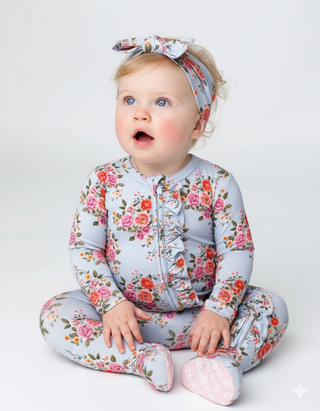 Baby in a floral outfit with a white background