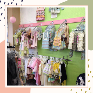 Store location card with address and operating hours on a colorful abstract background | Baby in Bloom | Kingfisher, OK