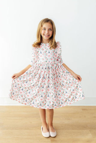 Young girl wearing a floral dress on a white background