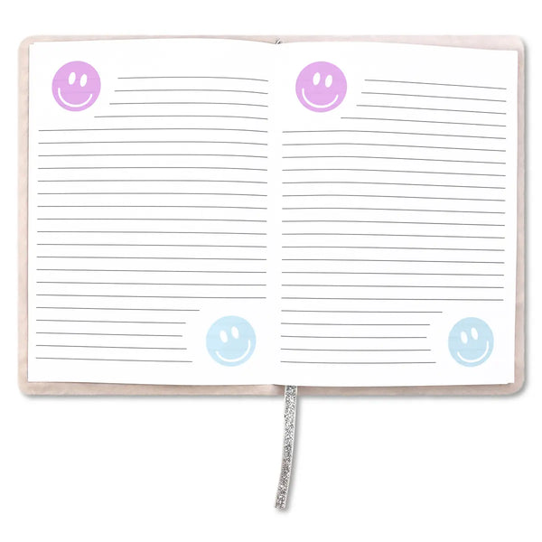 Open notebook with lined pages and smiley face stickers on a white background