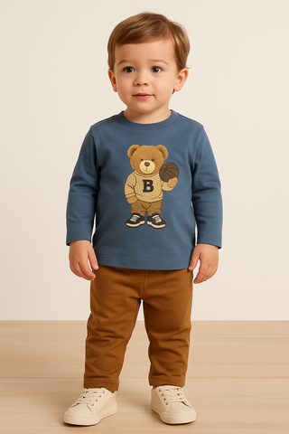 Child wearing a blue shirt with a teddy bear graphic on a plain background